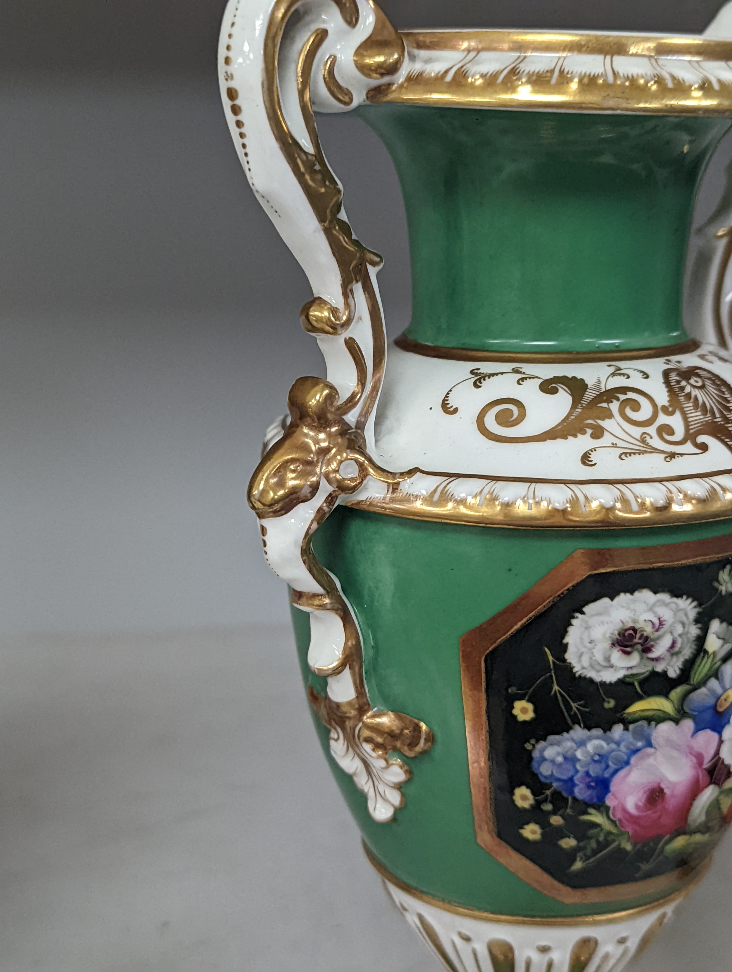 An English porcelain two handled vase painted with flowers in a panel on a green ground, probably Grainger Worcester, c.1830, height 24cm